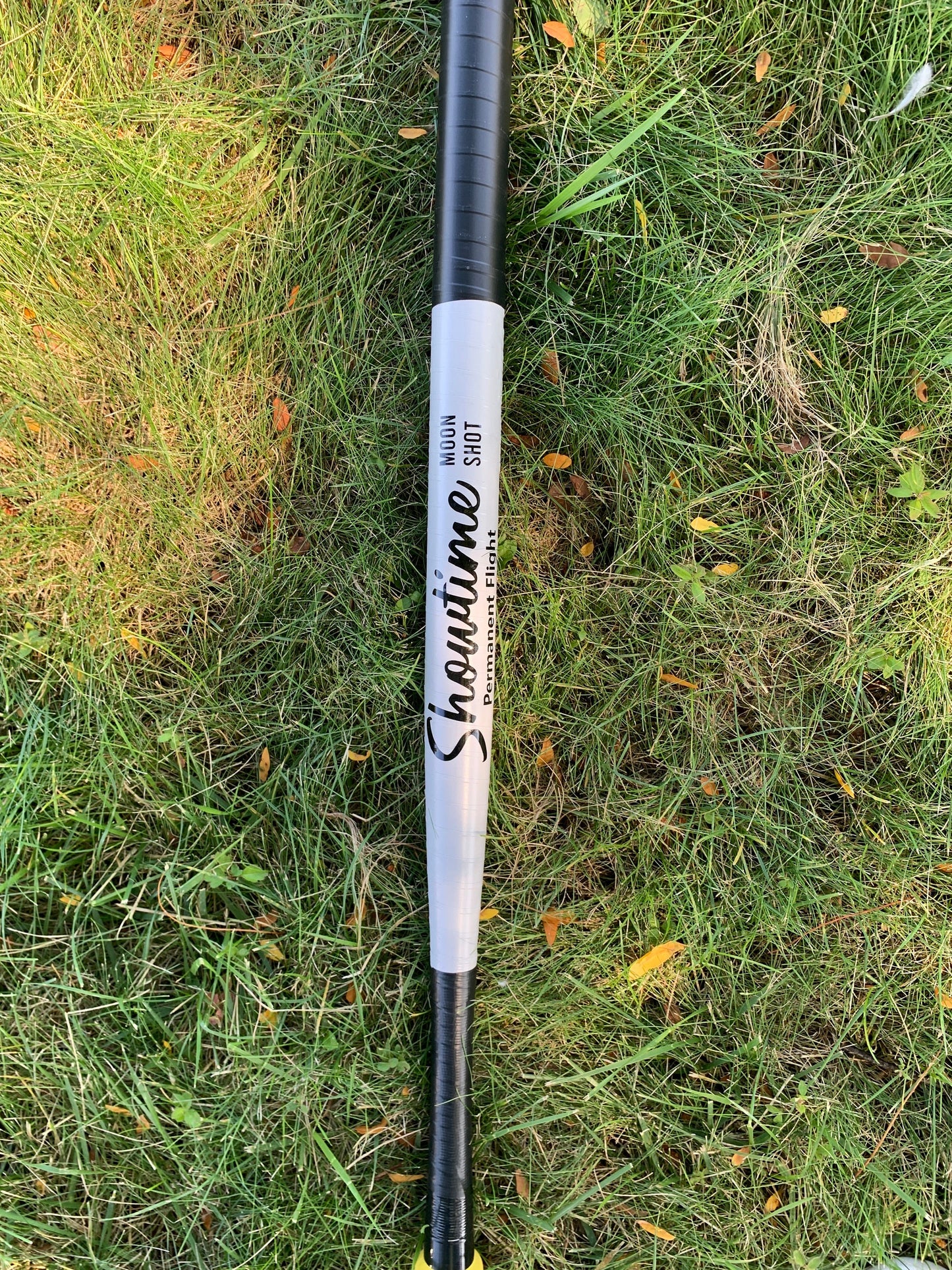 Custom wrapped wiffle ball bat with 'Showtime Moon Shot' design on grass
