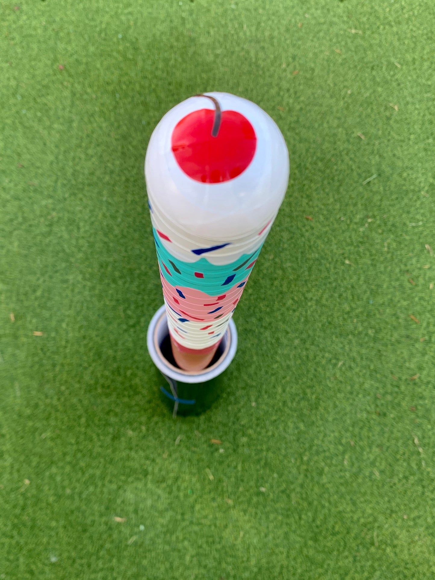 Custom wrapped WIFFLE bat with sprinkles and cherry design on green turf