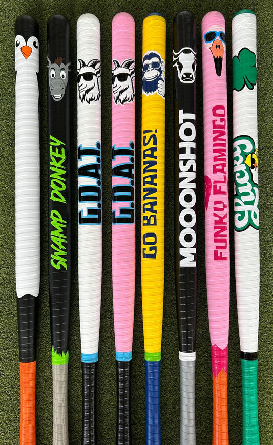 colorful custom wiffle bats on bright grass in a sunny backyard setting